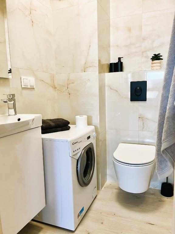 Bathroom with shower and washing machine